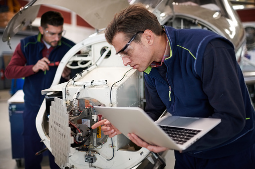 Aircraft mechanics in the hangar Aircraft mechanics in the hangar